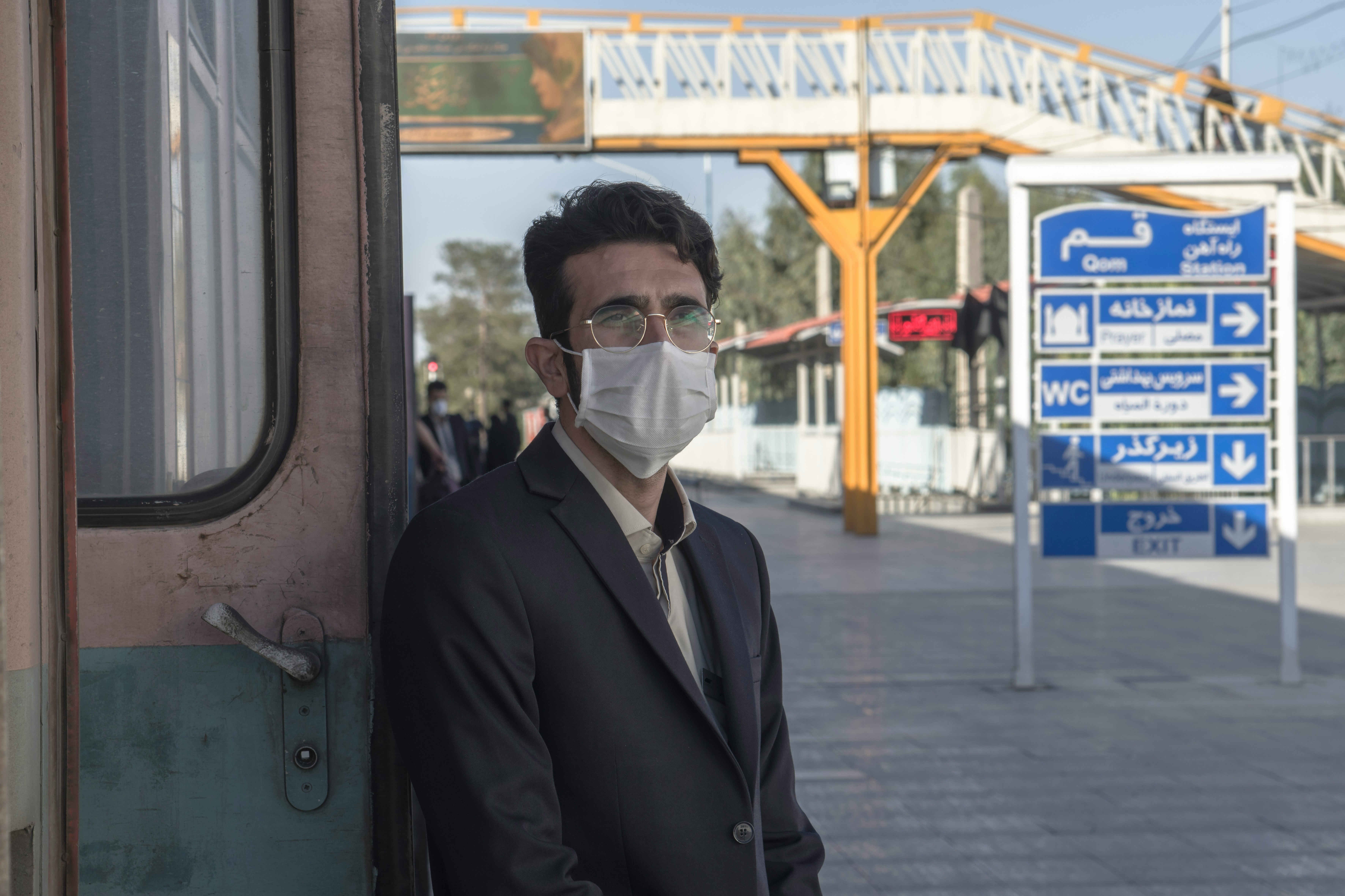 man in black suit jacket wearing white goggles